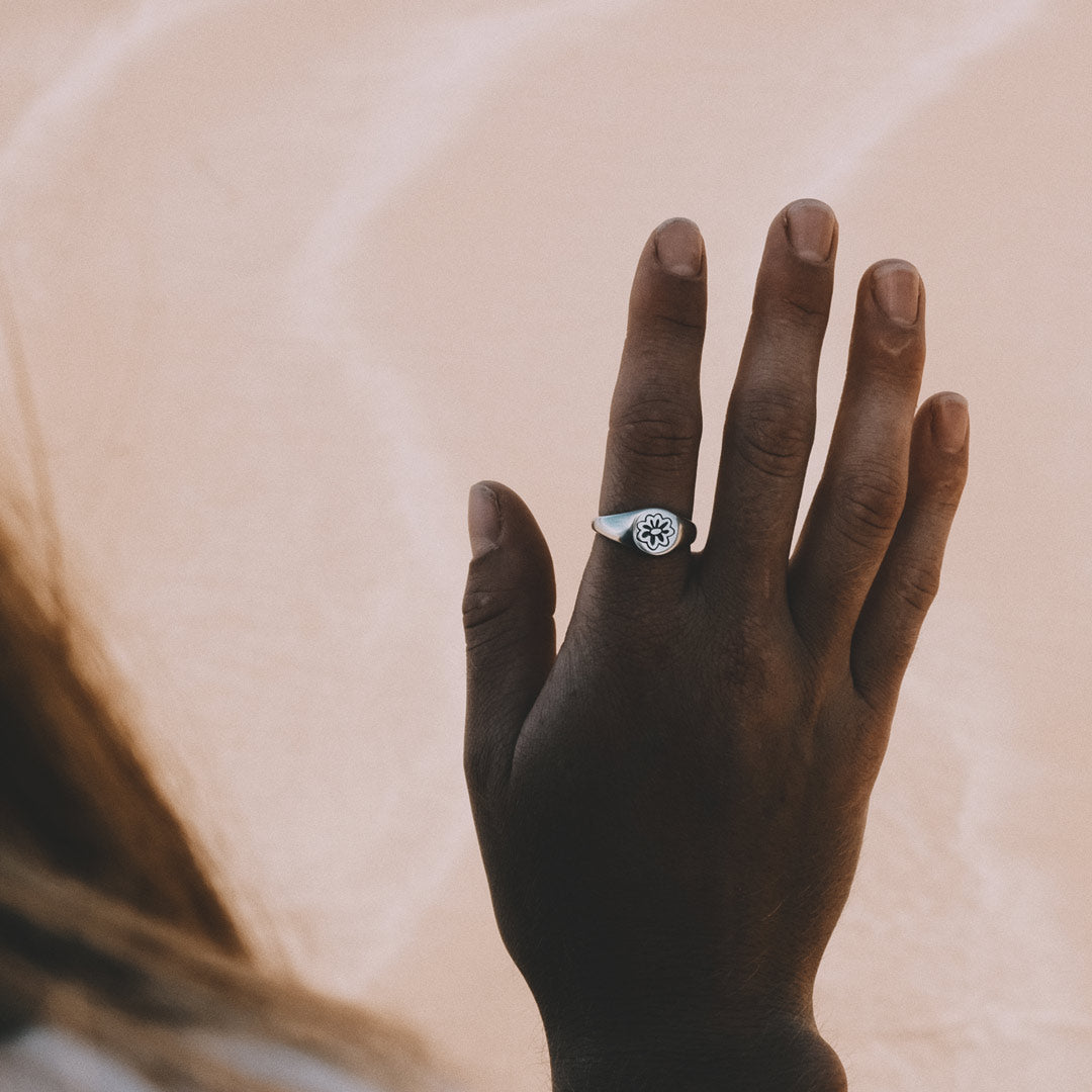 Woman wearing sterling silver flower ring at beach 